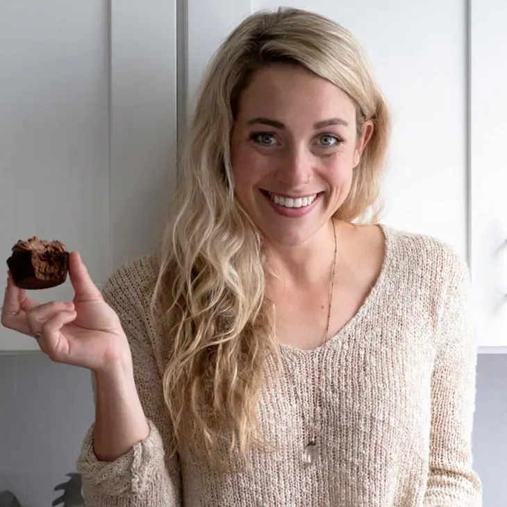portrait of lindsey hyland from little pine kitchen holding a chocolate cupcake