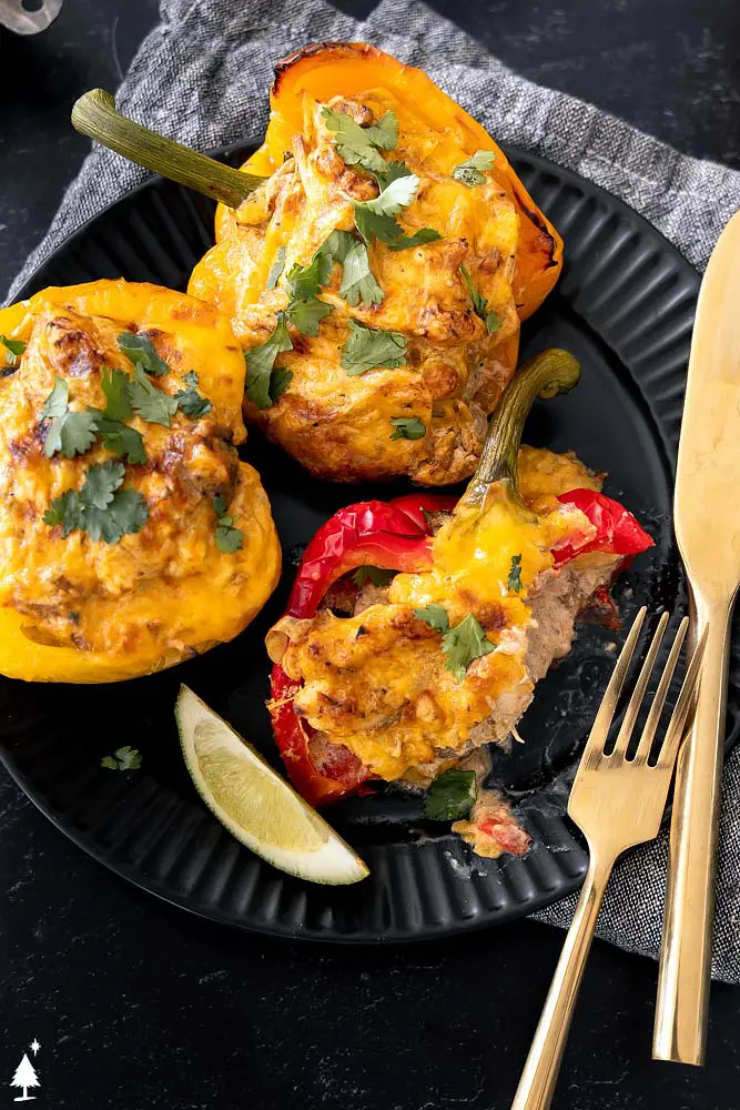 3 chicken stuffed peppers with a bite taken out of one. This keto chicken recipe doesn't contain rice.