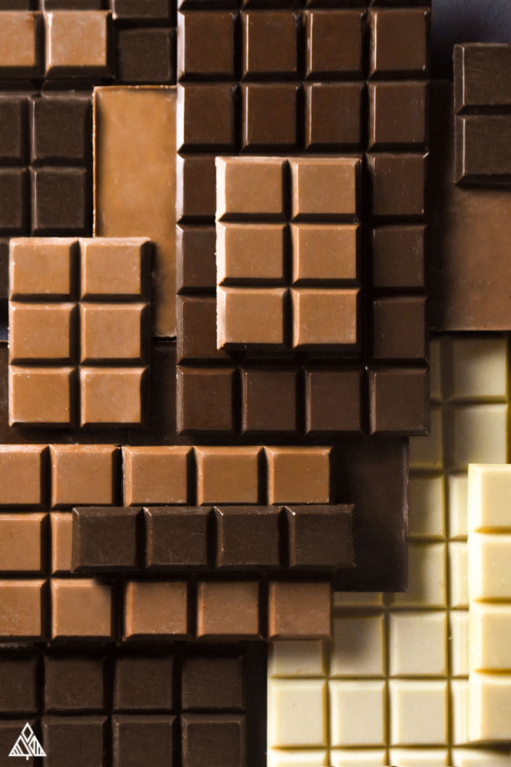 Low carb chocolate bars, white, milk and dark chocolate stacked on top of each other