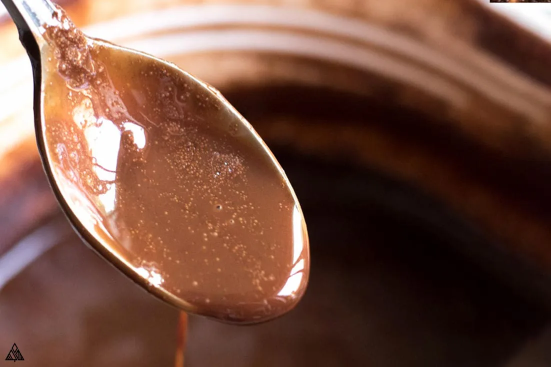 keto chocolate syrup dripping off a spoon