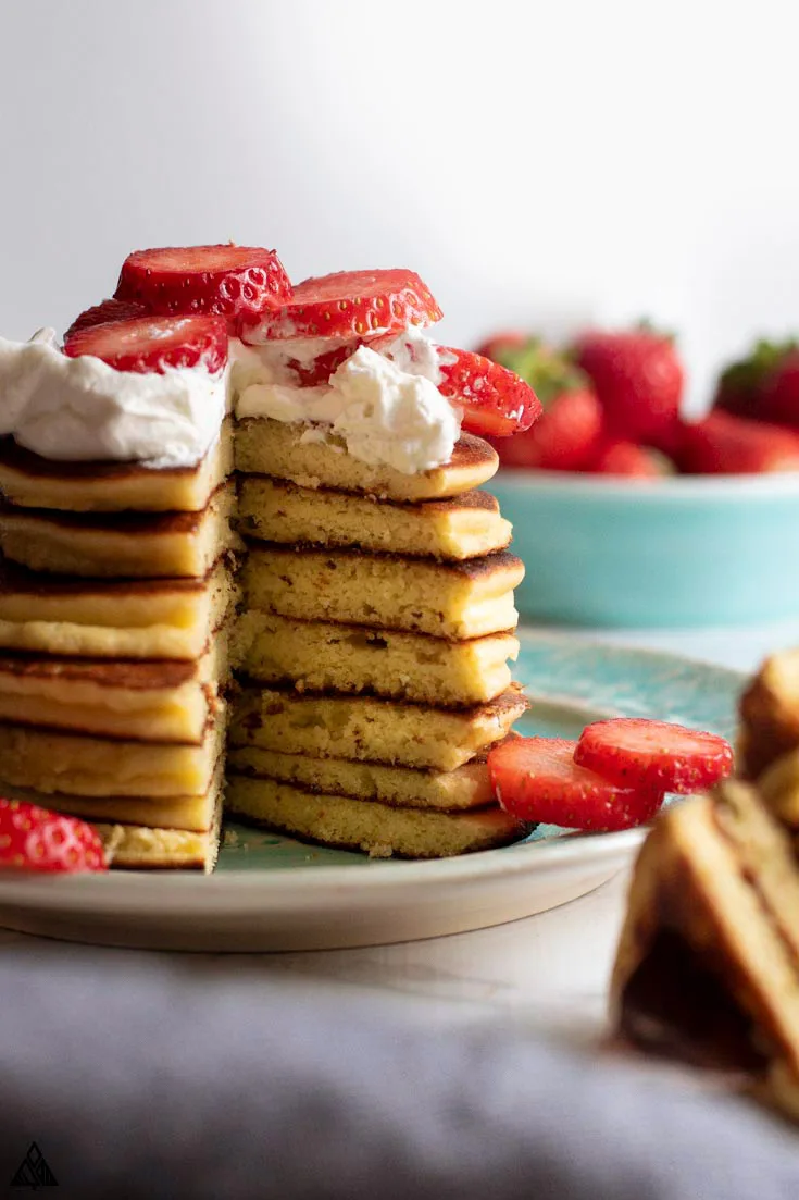 large stack of low carb pancakes with a bite removed