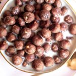 Low carb cocoa puffs in a bowl with milk