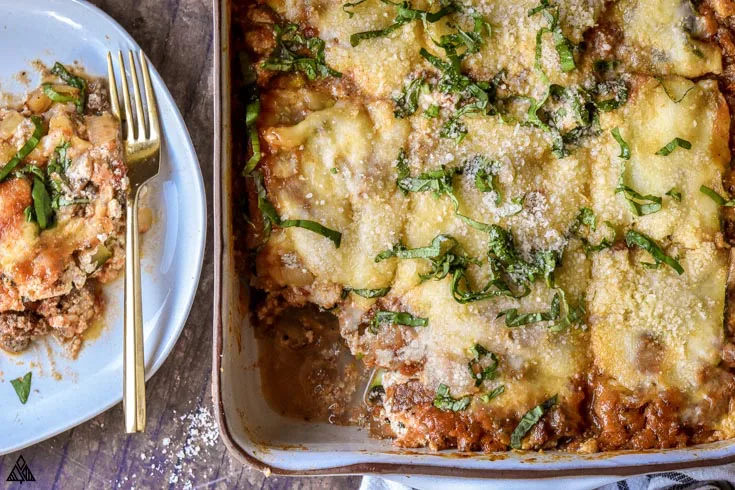 Top view of zucchini lasagna with a slice in a plate