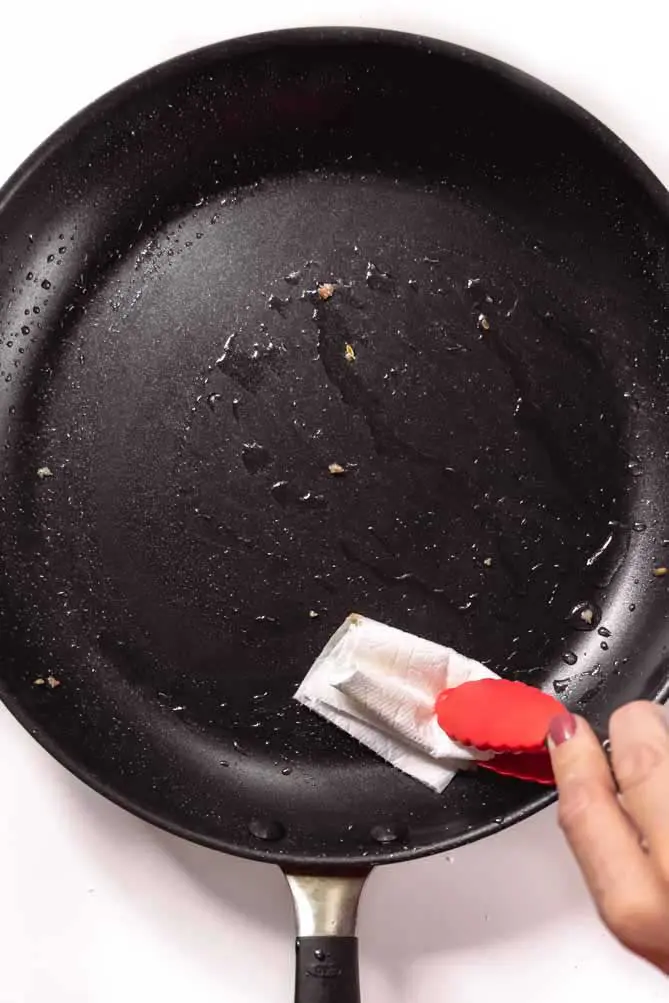 removing grease in a zucchini lasagna keto pan
