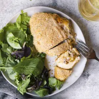 cream cheese stuffed chicken in a plate with fork