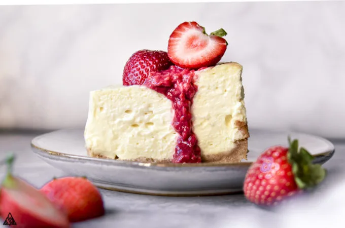Slice of low carb cheesecake with strawberries on top