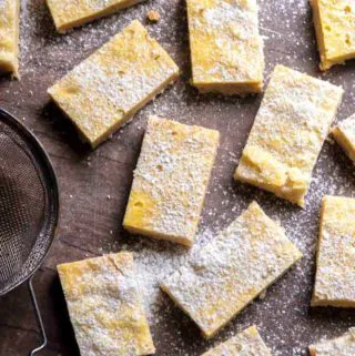 low carb lemon bars on a table with powdered erythritol on top