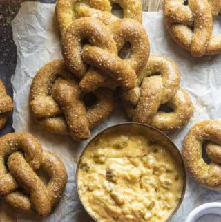 Low carb pretzels on a parchment paper with a bowl of dipping sauce