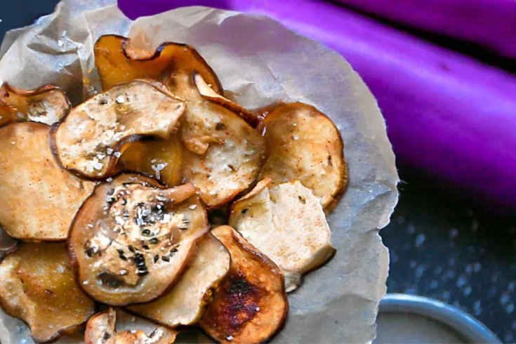 low carb chips made from eggplants with eggplant in background