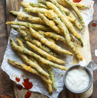 Low carb fried green beans on a parchment paper