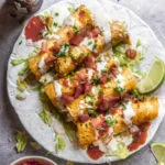 Plate of low carb taquitos with all the toppings