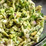 avocado chicken salad in a glass bowl on a black background