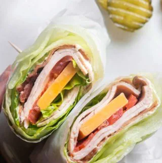 close up shot of turkey club wraps on a plate