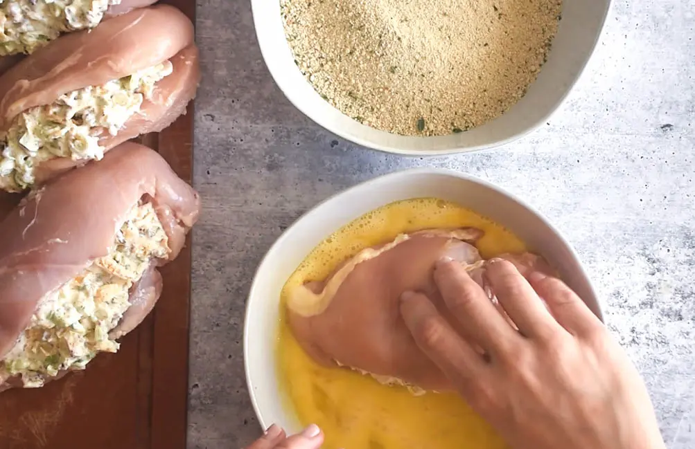 coating chicken breast and showing how to cook stuffed chicken breast