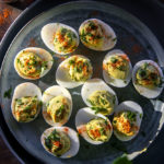 top view of delish avocado deviled eggs on a plate