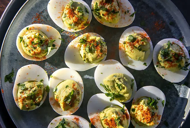 top view of delish avocado deviled eggs on a plate