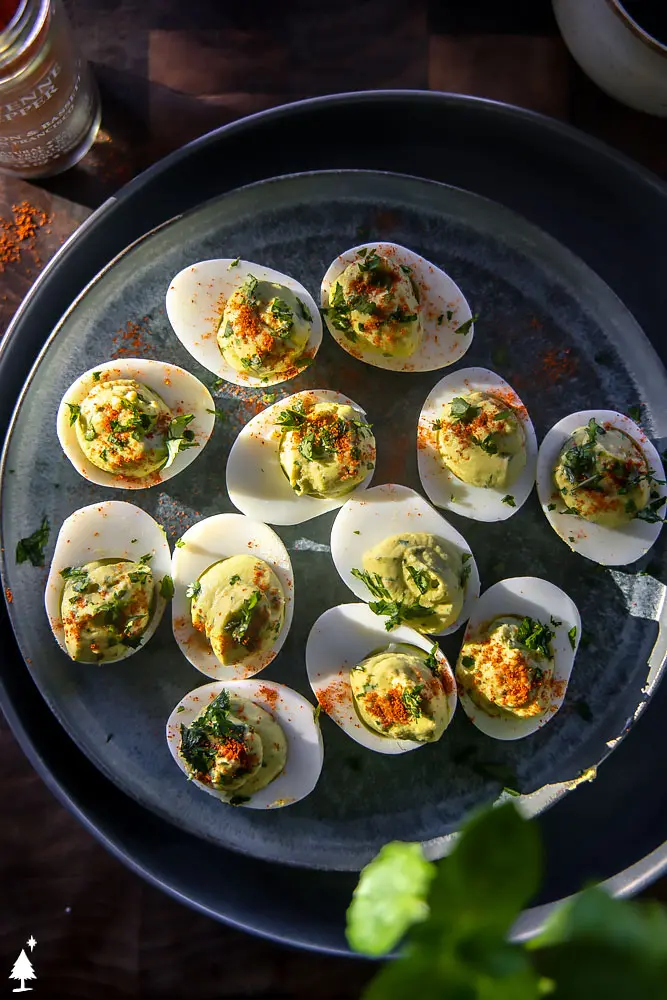 top view of deviled eggs and avocado on a plate