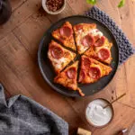 top view of chicken pizza crust on a platter