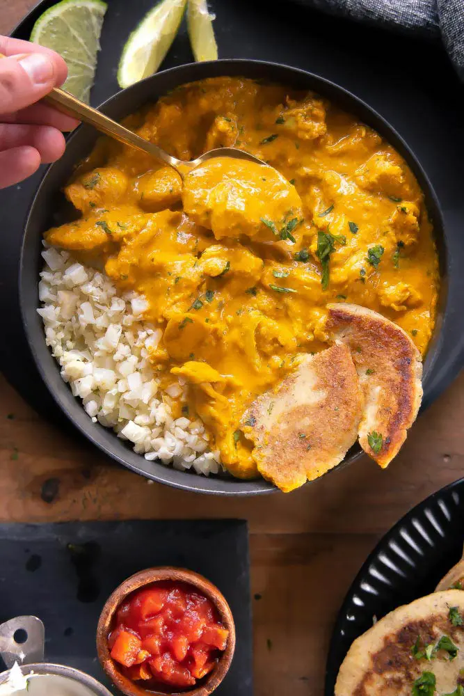 the best chicken curry with a thick sauce and a spoon scooping it up
