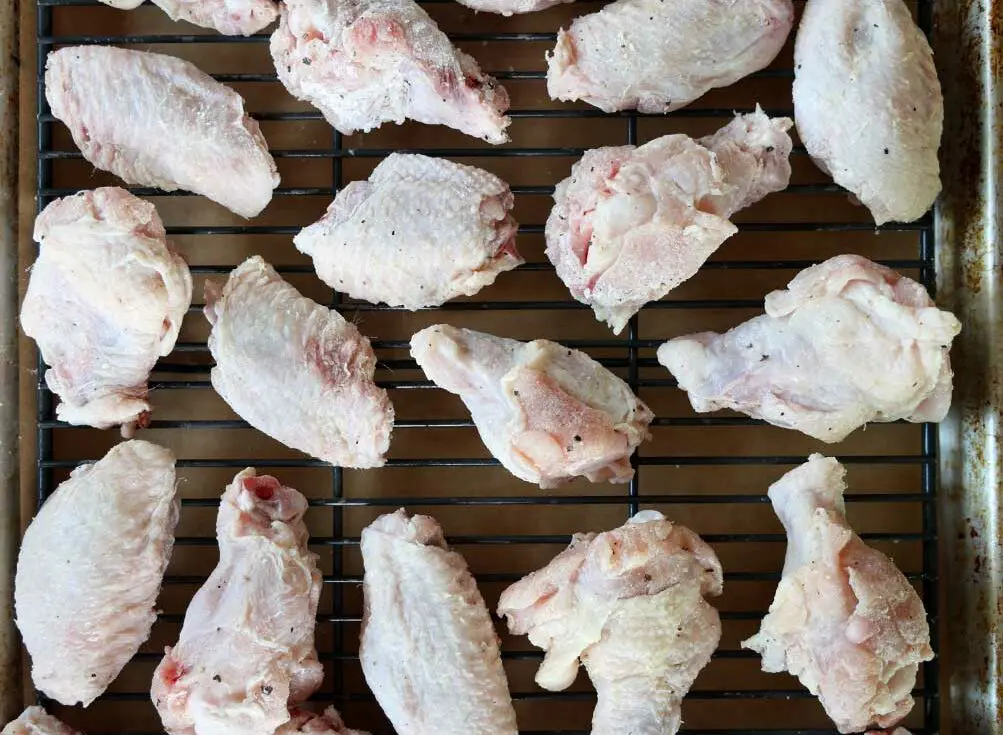 chicken wings on a rimmed baking sheet