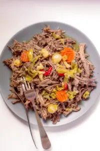 instant pot italian beef being shredded on a plate