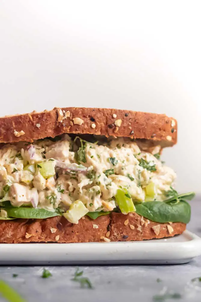 easy chicken salad sandwich with lettuce on a cutting boards