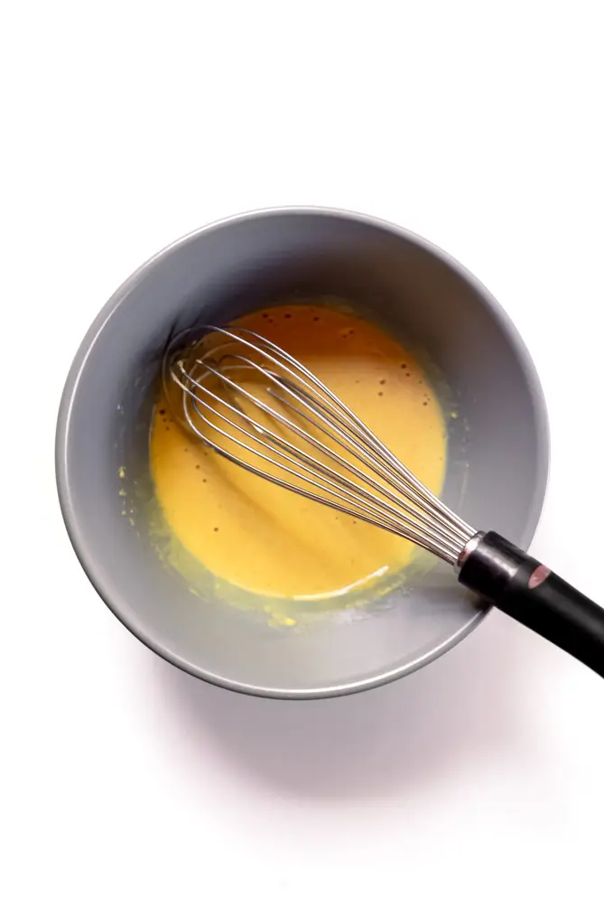 whisking the lemon juice, sugar, and mustard together