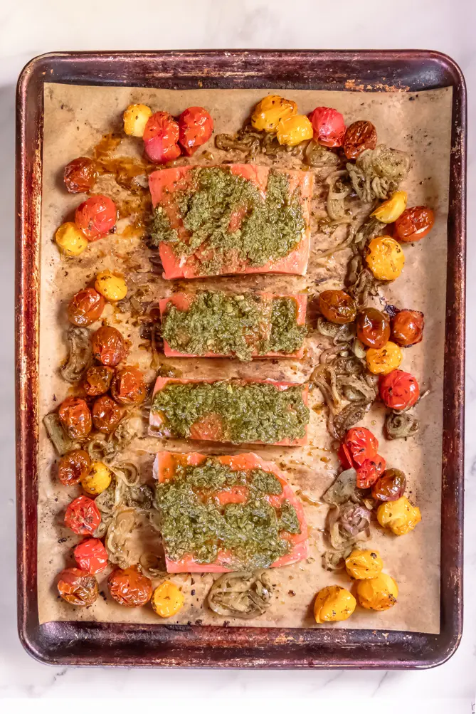closer view of pesto salmon baked in a sheet pan
