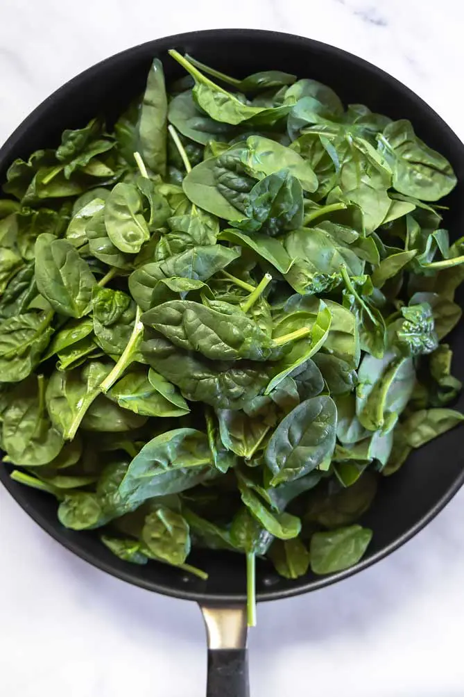 top view of healthy sauteed spinach in a pan