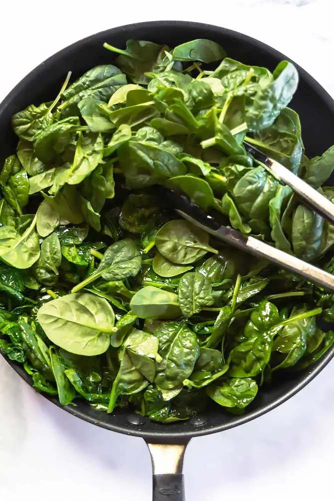 top view of healthy sauteed spinach in a pan