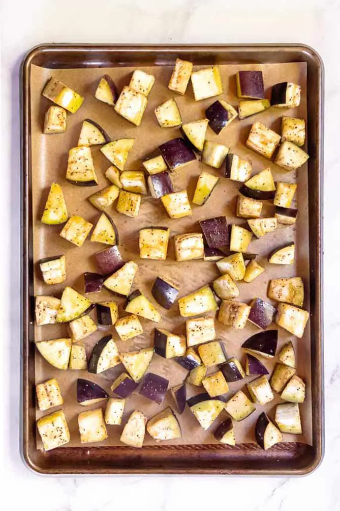 top view of roasted eggplant slices on a baking sheet 