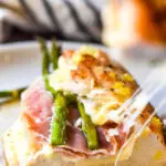 A slice of asparagus stuffed chicken in a plate