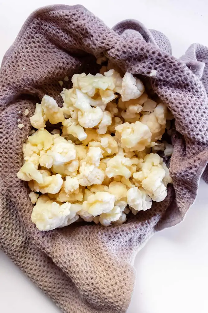 top view of top view of cauliflower lasagna keto cauliflower ringing out liquid