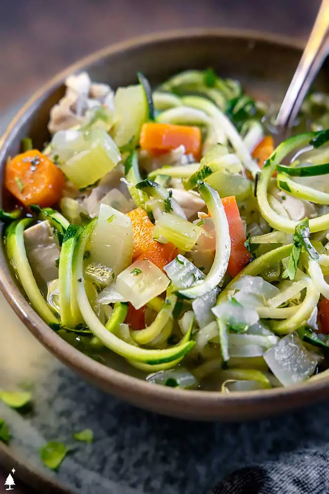 zucchini keto chicken noodle soup in a bowl from the front