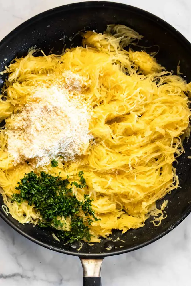 top view of spaghetti squash with parmesan and herbs