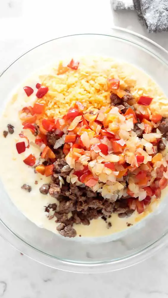 top view of low carb breakfast casserole ingredients on a mixing bowl