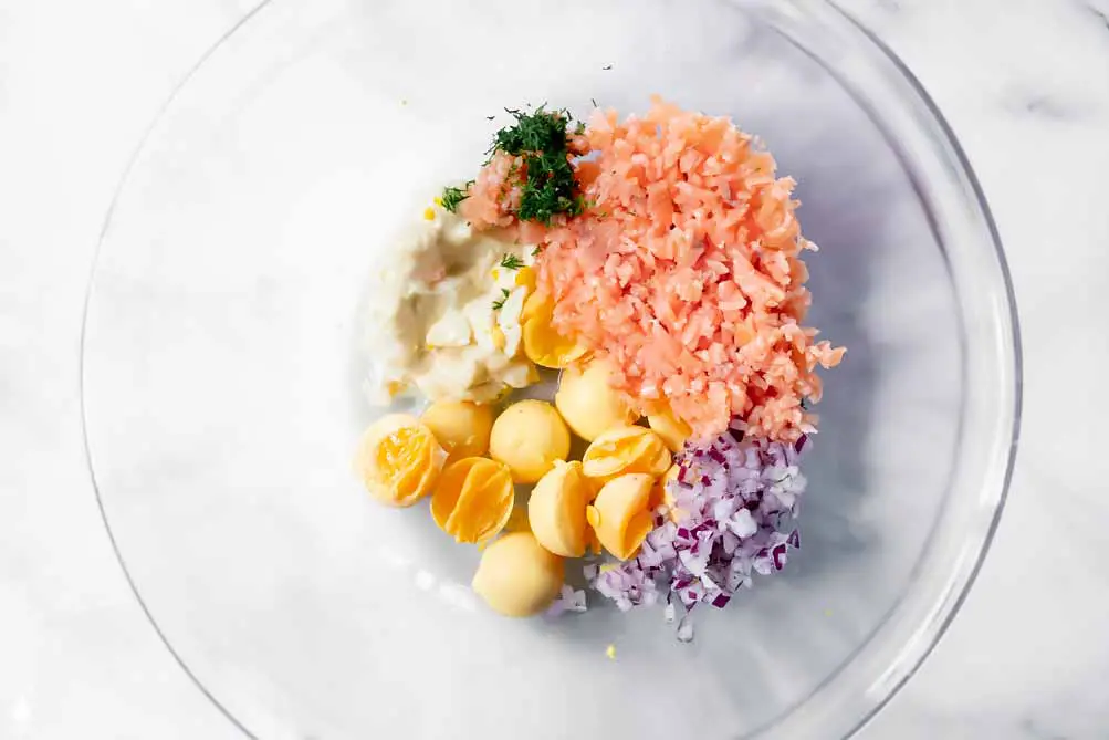 top view of smoked salmon hard boiled eggs' ingredients in a bowl