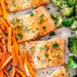 lemon pepper salmon recipe along with broccoli and carrots on a baking sheet