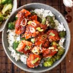 salmon bowl recipe from above, in a bed of rice with broccoli and green onions