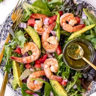 avocado shrimp salad on a plate with dressing