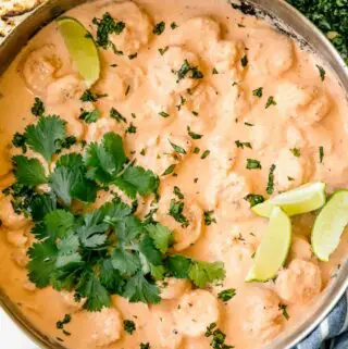 creamy chipotle shrimp in a pan with cilantro and limes