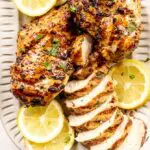 greek chicken marinade on a plate with lemon slices