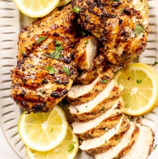 greek chicken marinade on a plate with lemon slices