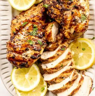 greek chicken marinade on a plate with lemon slices