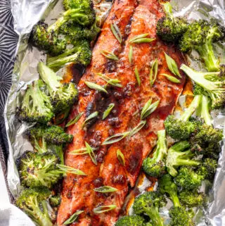 bourbon glazed salmon on a baking sheet with broccoli