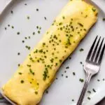 french omelette recipe on a plate with chives
