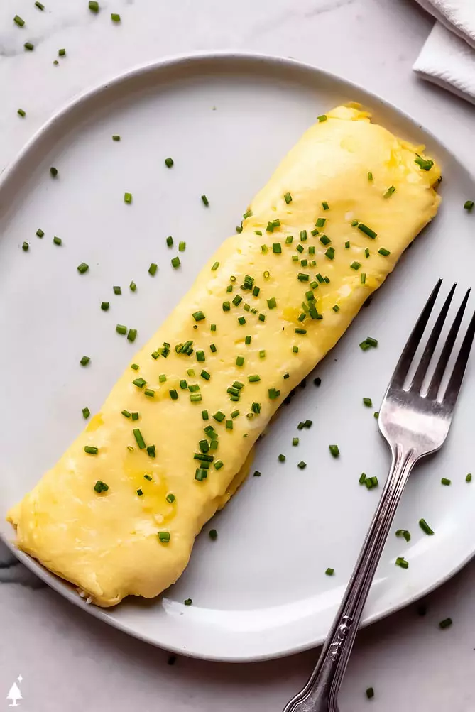 french omelette recipe on a plate with chives