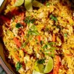 spaghetti squash pad thai in a pan with lime and cilantro on top