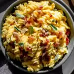 butternut squash pasta sauce with bacon and sage on top in a black bowl