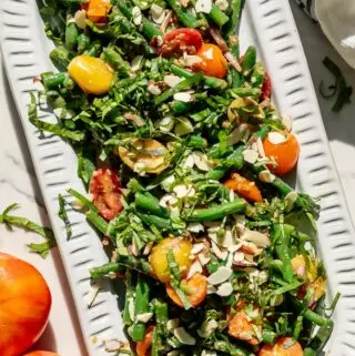 green bean salad recipe with tomatoes on a platter